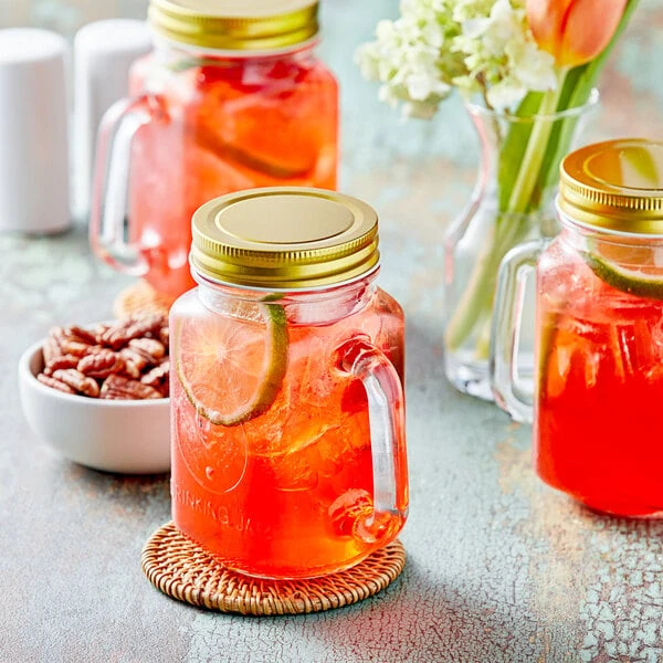 Acopa Rustic Charm 16 Oz. County Fair Drinking Jar / Mason Jar With Handle And Gold Metal Lid - 12/Case 1 Acopa Rustic Charm 16 Oz. County Fair Drinking Jar / Mason Jar With Handle And Gold Metal Lid - 12/Case